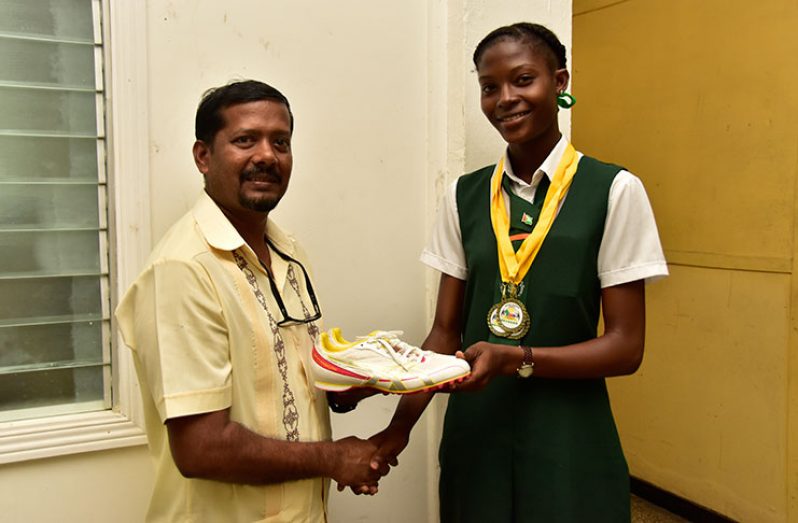 L-R Harri Narine presents running shoes to Joanna Archer.