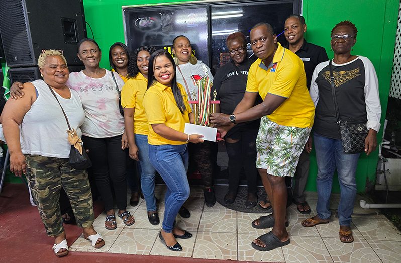 Marketing Director of GKMS Mrs. Tina Seabra-Gibson hands over the Trophy and sponsorship cheque to Mr. Roderick Harry in the presence of a few of the elated female captains, along with members of GKMS.