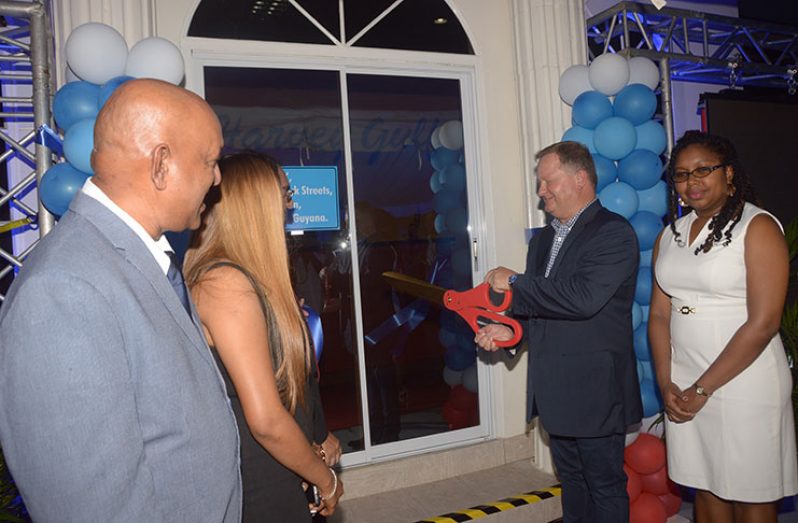 CEO of Harvey Gulf, Shane Guidry, cuts the ceremonial ribbon to declare the office open (Adrian Narine photo)