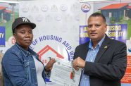 Minister of Housing and Water, Collin Croal, officially hands over the keys and electrical certificates during a brief ceremony at the Ministry’s headquarters