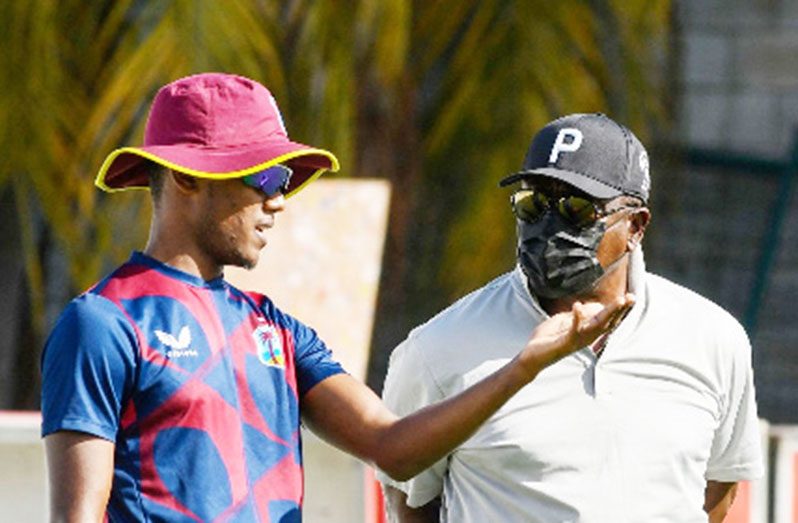 Chief selector, The Most Hon. Desmond Haynes (right), chats with left-arm spinner Akeal Hosein during the T20 series against England at Kensington Oval