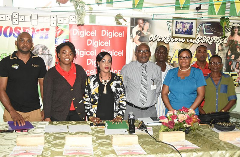 President of the GDA Faye Joseph (3rd left) and Digicel’s Events & Sponsorship executive Louanna Abrams (2nd left), pose with dominoes officials yesterday.