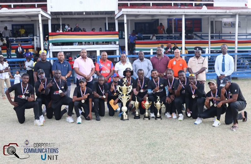 The victorious Headquarters players pose with their winnings along with Commissioner of Police Clifton Hicken and other senior Officers