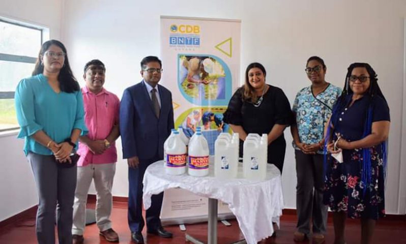 Senior Minister in the Office of the President with responsibility for Finance, Dr. Ashni Singh hands over essential cleaning and sanitising supplies to health officials in Region Six
