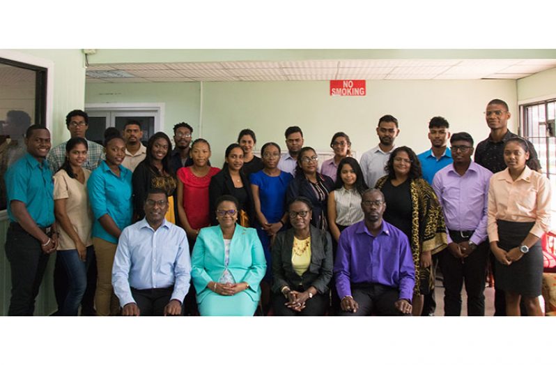 (Seated from left) Dr. Shamdeo Persaud, Chief Medical Officer; Volda Lawrence, Minister of Public Health; Dr. Karen Gordon- Campbell, Deputy Chief Medical Officer; and Glendon Fogenay, Deputy Permanent Secretary (Finance) with the 21 new health-care workers at their orientation and training programme