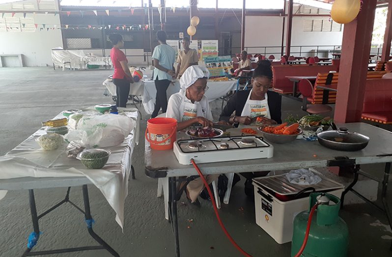 Members of the Food Policy Division of the Ministry of Public Health, demonstrate how to prepare a healthy meal with fresh vegetables