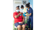 A female patient being attended to by a nurse