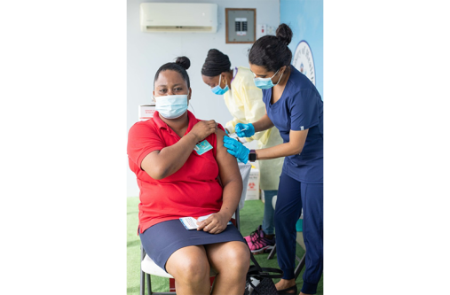 A female patient being attended to by a nurse