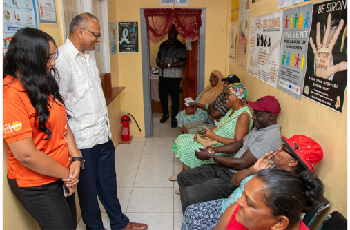 Minister of Health Dr Frank Anthony during a visit to the Ithaca Health Centre in Region Five to distribute Universal Health, Eye Testing, Spectacles, and Cervical Cancer Screening Vouchers to residents (MoH photo)