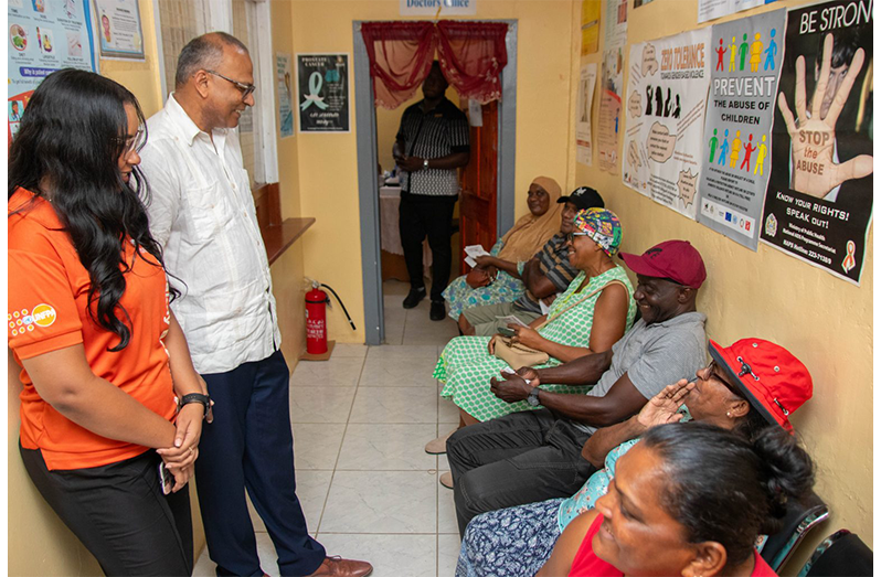 Minister of Health Dr Frank Anthony during a visit to the Ithaca Health Centre in Region Five to distribute Universal Health, Eye Testing, Spectacles, and Cervical Cancer Screening Vouchers to residents (MoH photo)