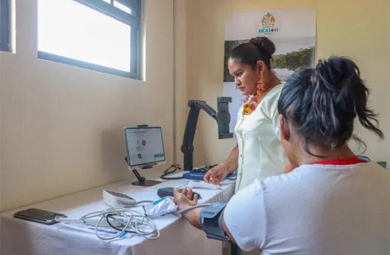Health worker assisting a patient at the telemedicine site in Region Nine