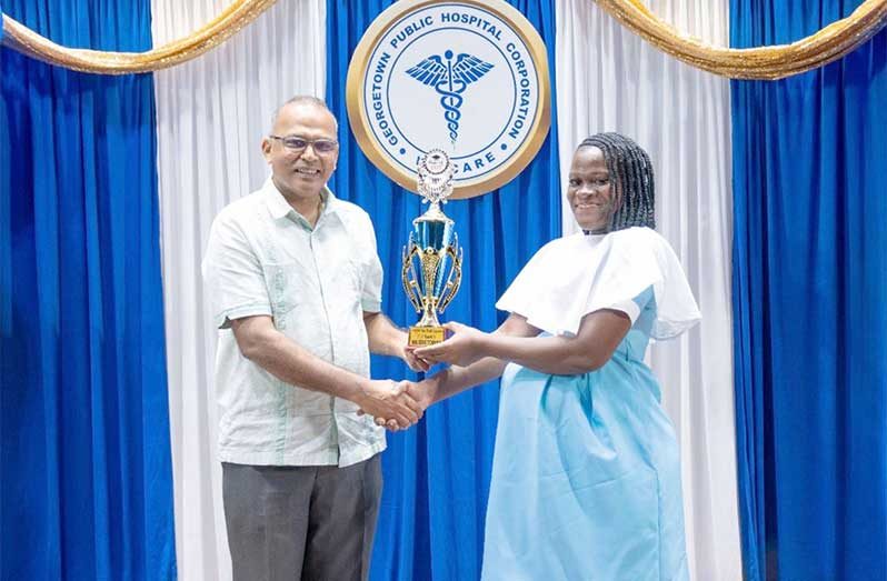Minister of Health, Dr. Frank Anthony, presented the Valedictorian Trophy to Michelle Boyer in recognition of her outstanding performance during the Patient Care Assistant training programme