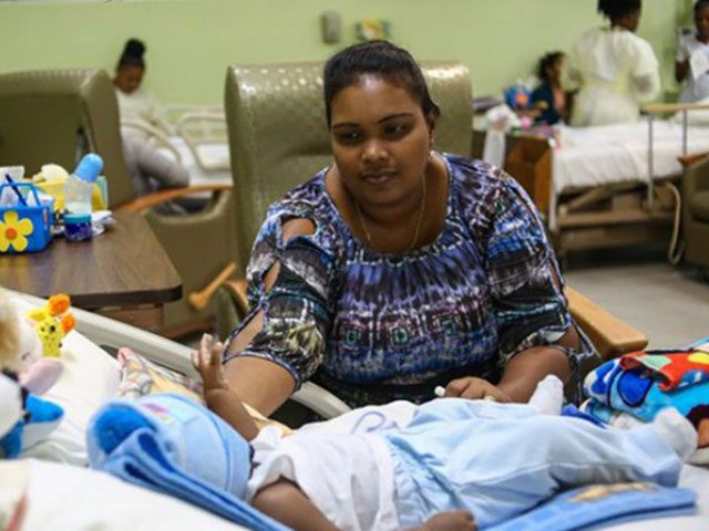 Bibi Shareema Haleem, mother of one of the babies who underwent heart surgery, tends to her baby boy as he responds to recovery treatment at the Georgetown Public Hospital Corporation (GPHC)