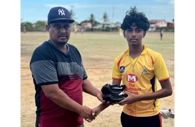 Coach Hemraj presented batting gloves to Rahul Sheeran