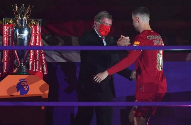 Sir Kenny Dalglish presented Jordan Henderson with the Premier League trophy on Wednesday.