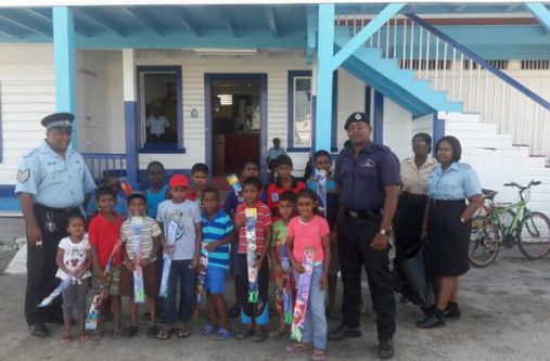 Children from the Henrietta-Anna Regina Youth Group received kites from ranks of Anna Regina Police Station