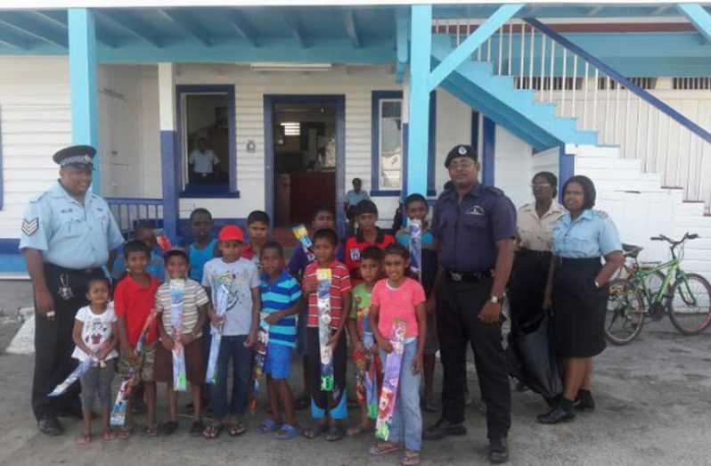 Children from the Henrietta-Anna Regina Youth Group received kites from ranks of Anna Regina Police Station