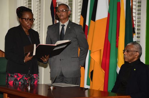 Henry Commissioner of the Lands Commission of Inquiry (CoI),Paulette Henry,taking the oath of office before President David Granger at State House