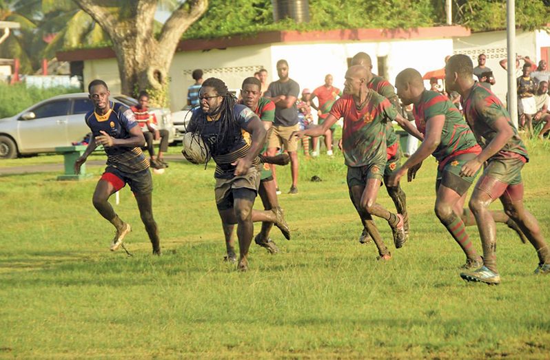 Theodore Henry (with ball) scored one try and one conversion for Police Falcon while Owen Adonis (left) led with two tries. (Adrian Narine Photo)