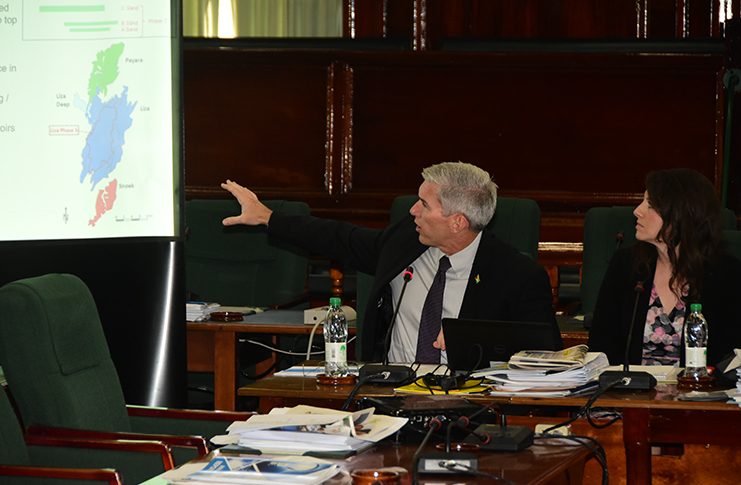 Country Manager EEPGL, Rod Henson points to his presentation on Friday. Also in photo is Deedra Moe, the company’s Senior Director for Public and Government Affairs (Adrian Narine Photo)