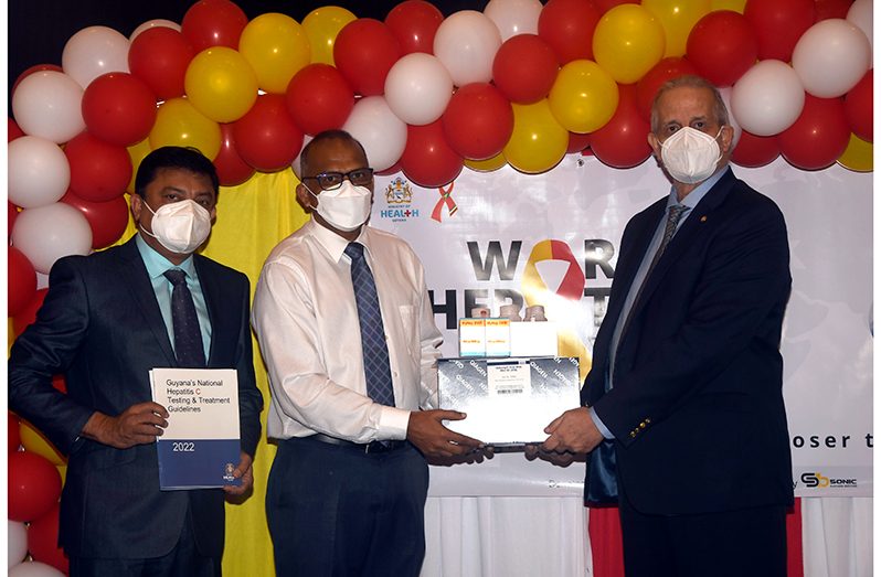 PAHO Representative to Guyana, Dr Luis Codina (right), hands over drugs procured for the newly launched Hepatitis C Treatment programme to Minister of Health, Dr Frank Anthony (Second from left). Also in photo is Chief Medical Officer Dr Narine Singh (first from left) (Adrian Narine photo)