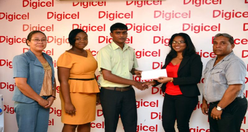 Digicel Communications Manager Vidya Bijlall-Sanichara handing over the cheque Wednesday to Besham Ramsaywack, Project Officer/Heritage Coordinator With them are, from left, Elke Rodrigues, Louanna Abrams, and Ivan Persaud (Photo by Adrian Narine)