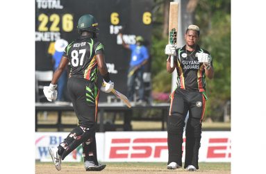 Shimron Hetmyer raises his bat after a blistering 113 off 80 balls and shared  a record 194 for the  5th wicket  with Raymon Reifer (90)