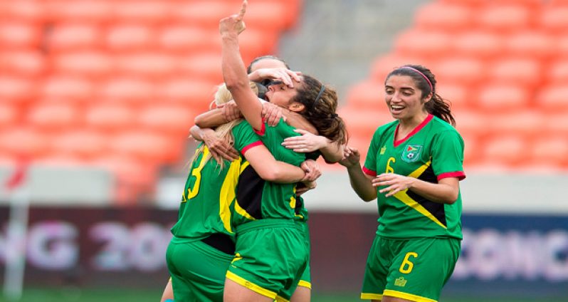 Alison Heydorn (showing the #1 sign), is swarmed by team-mates after scoring Guyana’s game winner against Guatemala last Sunday.