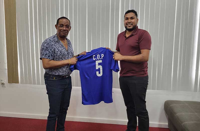 Commissioner of Police (ag) Clifton Hicken (left) and Romario Samaroo of FL Sport.