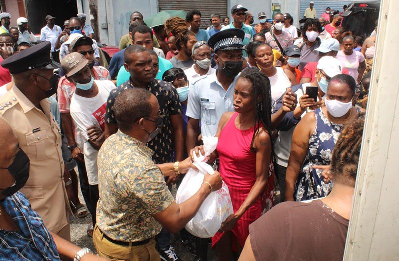 Commissioner of Police (ag), Clifton Hicken shares out hampers throughout his visits to various communities in Georgetown and its environs