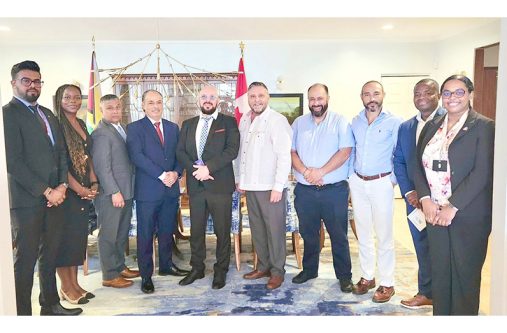High Commissioner Sébastien Sigouin (in white shirt jack) surrounded by some members of the delegation and from left, the High Commission`s Trade Commissioner, Omesh Balmacoon and Senior Trade Commissioner, Yvanna Nganou