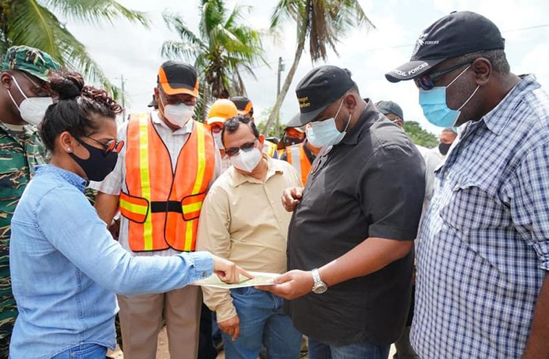 President Irfaan Ali along with Prime Minister, Brigadier (rt’d) Mark Phillips; Minister of Public Works, Juan Edghill and other officials examining what appears to be a map of the area (Office of the President photo)