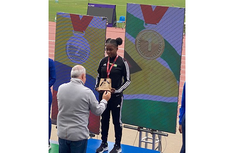 Sprinter Athaleyha Hinckson collecting her 100 metres gold medal