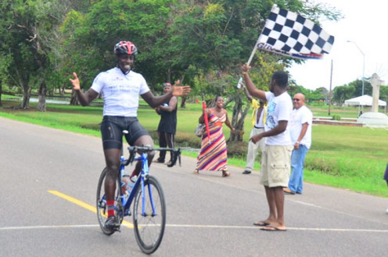 Yes I did it! The smile on the face of Orville Hinds says it all, as he crosses the finish line alone to take the top prize in this year’s Digicel ‘Cancer Awareness Ride’. (Photos by Adrian Narine)