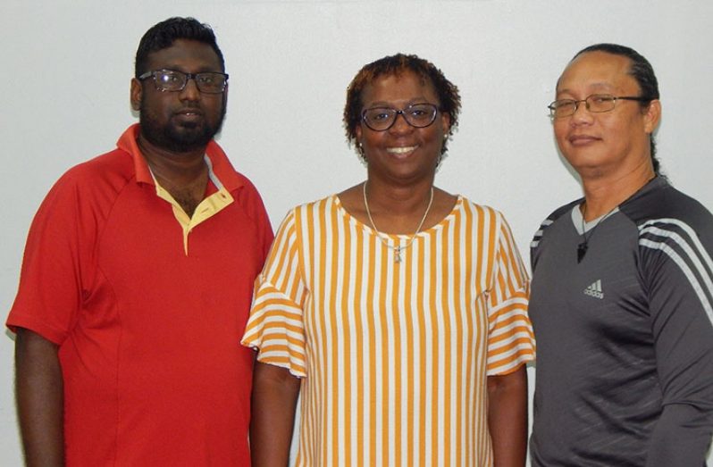 Ms Gail Craig-Archer is flanked by coach Madray (left) and coach Hing (right).