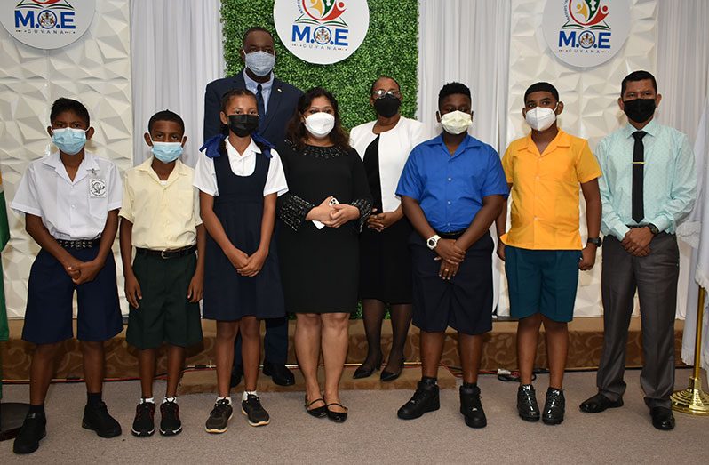 Minister of Education Priya Manickchand with the hinterland top NGSA performers, from left: Kellon Jordon, Leandro Marcello, Aisha De Freitas, Troy Roberts, and Sabastian Khan at the announcement ceremony (Elvin Croker Photos)