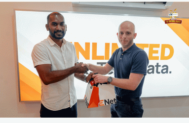 Co-Director of Kares One Guyana T10 Blast, Yusuf Ali, collects the two cellphones from Robert Hiscock, Head of Mobile Networks at ENet