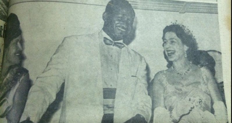 A smiling Monarch witnesses with unconcealed pleasure the final rousing tribute of the Guyanese people. With the Queen on the Royal yacht Britanna are Prime Minister Forbes Burnham and Mrs. Rahman Gajraj, wife of the Mayor of Georgetown