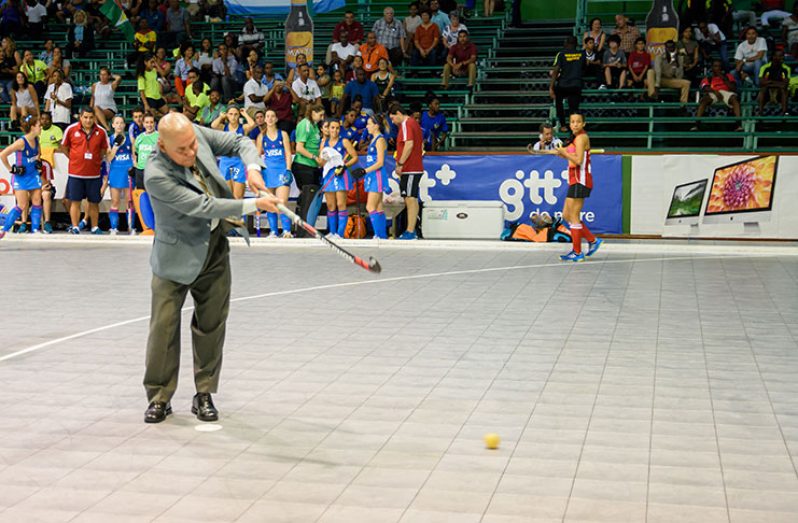 Minister George Norton fires off the opening shot of the Exxon Mobil Indoor Pan American Hockey Championship. Director of Sport Christopher Jones, Minister of Business Dominic Gaskin, officials from Exxon Mobil and the GHB were also in attendance. (Samuel Maughn photo)