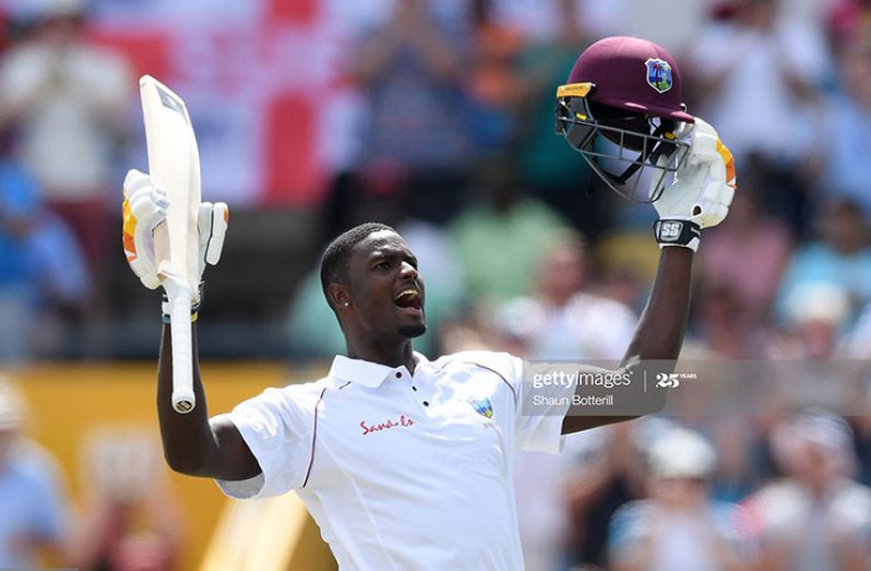 West Indies captain Jason Holder celebrates reaching his 100 during Day Three of the First Test match between England and West Indies at Kensington Oval on January 25, 2019 in Bridgetown, Barbados. (Photo by Shaun Botterill/Getty Images)