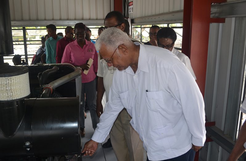 Minister of Agriculture, Noel Holder activates the new pump during the commissioning ceremony