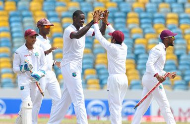 Jason Holder celebrates with
Guyanese Vishaul Singh after
West Indies victory. (WICB)
