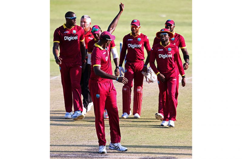 Man-of-the-Match Jason Holder leads West Indies off the field after their 62-run win in Harare. (AFP photo)