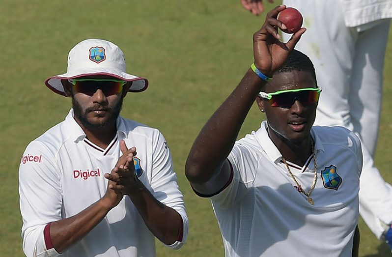 Jason Holder and Devendra Bishoo lead West Indies off the field on the 4t day in Sharjah. Holder claimed career-best figures of 5 for 30, while Bishoo took 18 wickets in the series.