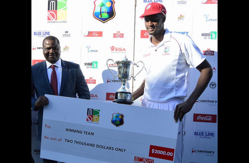 Skipper Jason Holder receives the series trophy after the second and final Test against Zimbabwe ended in a draw.
