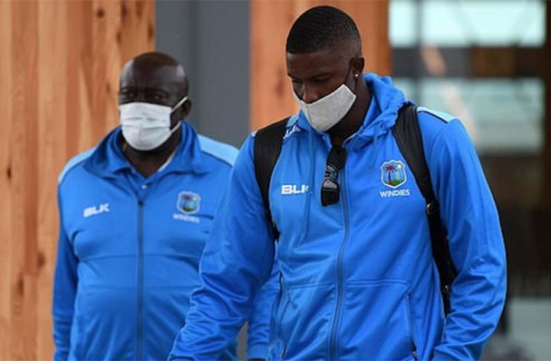 Captain Jason Holder (right), along with assistant coach Roddy Estwick, leaves Manchester Airport after arriving from the Caribbean on Tuesday.