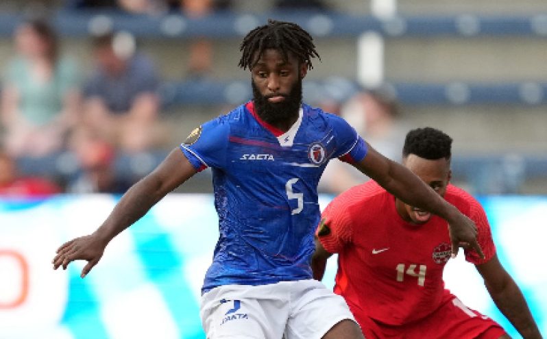 Haiti’s goalscorer Stephane Lambese holds off his marker during Thursday’s contest.