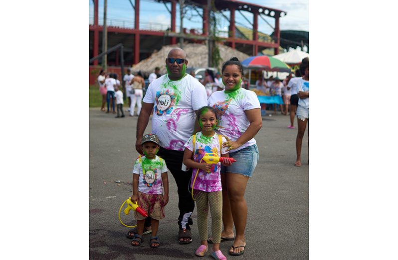 Vanessa Ram and her family travelled all the way from Vreed-en-Hoop, West Bank Demerara, so her children could fully experience the joy of Phagwah (Shaniya Harding photo)