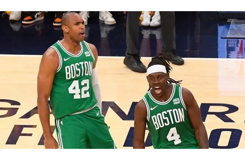 Al Horford and Jrue Holiday celebrate Boston's victory [Getty Images]