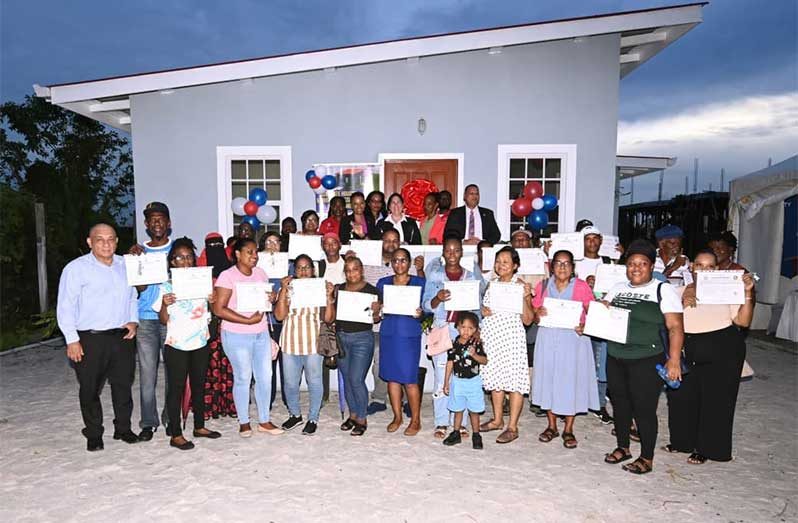 Minister of Housing and Water Collin Croal, Minister within the Ministry Vanessa Benn and Inter-American Development Bank (IDB) Country Representative Lorena Solórzano-Salazar join newly minted homeowners and officials of the Central Housing and Planning Authority (CH&PA) during Tuesday’s key handing-over ceremony for 28 families under the Adequate Housing and Urban Accessibility Programme (AHUAP).